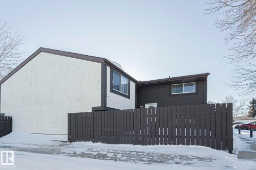 View of snow covered exterior with stucco siding - 1526 69 Street Nw, Edmonton, AB - Outdoor With Exterior