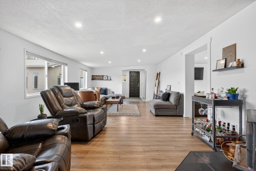Living area with light wood finished floors, a textured ceiling, and recessed lighting - 23509A Twp Road 484, Rural Leduc County, AB - Indoor Photo Showing Living Room