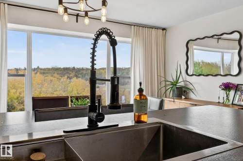 Kitchen with a chandelier and healthy amount of natural light - 23509A Twp Road 484, Rural Leduc County, AB - Indoor