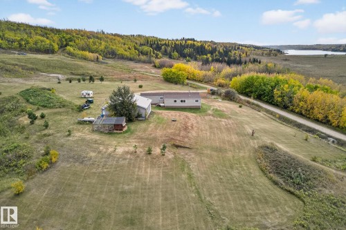 View of rural area featuring a nearby body of water and a heavily wooded area - 23509A Twp Road 484, Rural Leduc County, AB - Outdoor With View