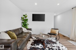 Living area with recessed lighting and light wood-type flooring - 
