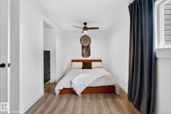 Bedroom with wood finished floors and a ceiling fan - 