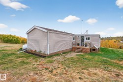 Back of property with a deck and a yard - 