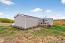 Back of property with a deck and a yard - 23509A Twp Road 484, Rural Leduc County, AB  - Outdoor 
