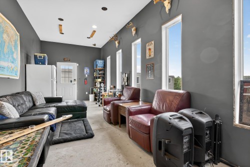 Living area featuring unfinished concrete flooring - 23509A Twp Road 484, Rural Leduc County, AB - Indoor