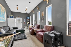 Living area featuring unfinished concrete flooring - 