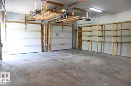 Garage featuring a garage door opener - 23509A Twp Road 484, Rural Leduc County, AB - Indoor Photo Showing Garage