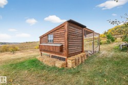 View of chicken coop with a view of countryside and a yard - 