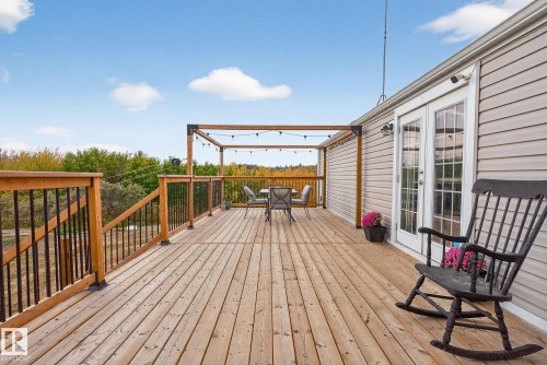 Wooden terrace with outdoor dining area and french doors - 23509A Twp Road 484, Rural Leduc County, AB - Outdoor With Deck Patio Veranda With Exterior