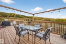 Deck featuring outdoor dining space, a grill, and a view of trees - 23509A Twp Road 484, Rural Leduc County, AB  - Outdoor With Deck Patio Veranda With Exterior 