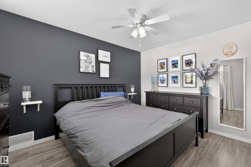 Bedroom featuring light wood-type flooring and ceiling fan - 7719 71 Avenue, Edmonton, AB - Indoor Photo Showing Bedroom