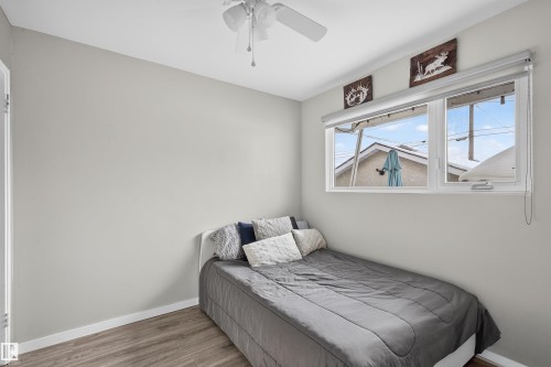 Bedroom featuring wood finished floors and a ceiling fan - 7719 71 Avenue, Edmonton, AB - Indoor Photo Showing Bedroom
