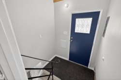 Entrance foyer featuring electric panel and light carpet - 