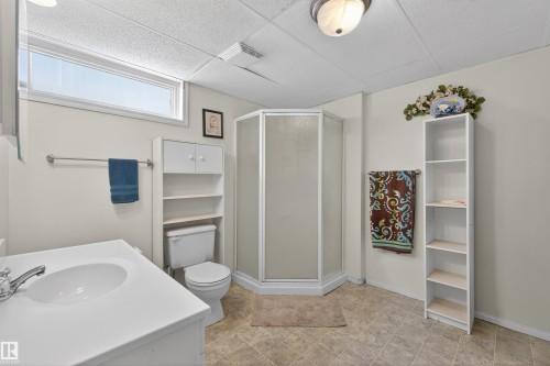 Bathroom featuring a shower stall, a paneled ceiling, vanity, and a closet - 7719 71 Avenue, Edmonton, AB - Indoor Photo Showing Bathroom
