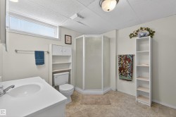 Bathroom featuring a shower stall, a paneled ceiling, vanity, and a closet - 