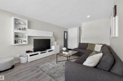 Living room with light wood finished floors and a textured ceiling - 