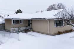 Snow covered property featuring stucco siding - 