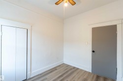 Unfurnished bedroom with wood finished floors, ceiling fan, and a closet - 