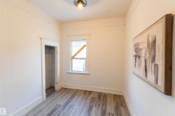 Unfurnished bedroom with wood finished floors and a closet - 