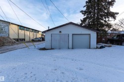 Snow covered garage featuring a detached garage - 