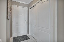 Doorway to outside featuring tile patterned floors and crown molding - 