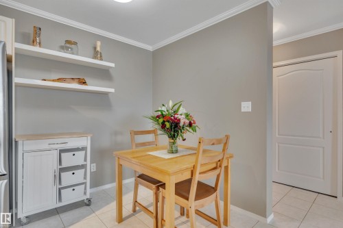 Dining space featuring light tile patterned flooring and ornamental molding - 203 35 Sir Winston Churchill Avenue, St. Albert, AB - Indoor Photo Showing Dining Room