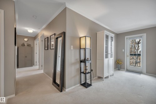 Hallway featuring light carpet and ornamental molding - 203 35 Sir Winston Churchill Avenue, St. Albert, AB - Indoor Photo Showing Other Room