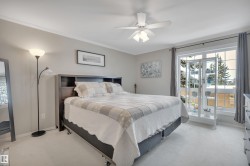 Bedroom featuring light colored carpet, ceiling fan, and crown molding - 