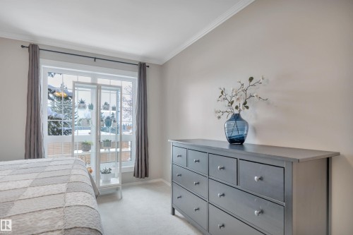 Bedroom with light carpet and crown molding - 203 35 Sir Winston Churchill Avenue, St. Albert, AB - Indoor Photo Showing Bedroom