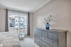 Bedroom with light carpet and crown molding - 