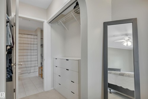 Walk in closet with ceiling fan and light tile patterned flooring - 203 35 Sir Winston Churchill Avenue, St. Albert, AB - Indoor