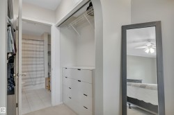 Walk in closet with ceiling fan and light tile patterned flooring - 