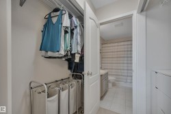 Walk in closet featuring light tile patterned floors - 