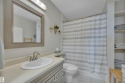 Bathroom featuring vanity, light tile patterned flooring, and shower / tub combo - 