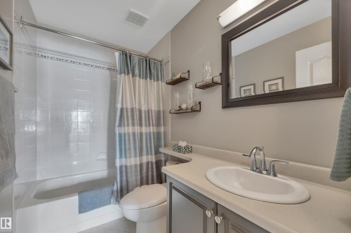 Bathroom featuring vanity and shower / bathtub combination with curtain - 203 35 Sir Winston Churchill Avenue, St. Albert, AB - Indoor Photo Showing Bathroom
