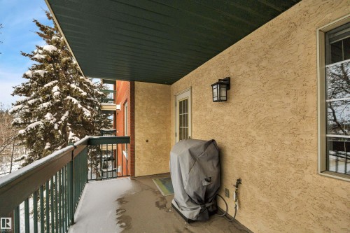 Snow covered back of property with grilling area - 203 35 Sir Winston Churchill Avenue, St. Albert, AB - Outdoor With Exterior