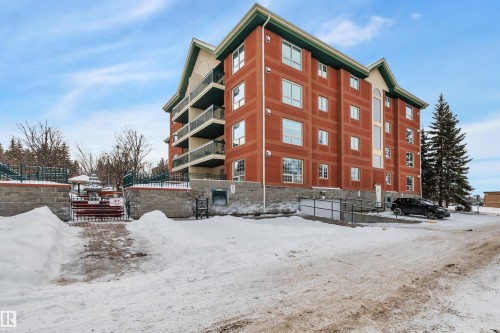 Snow covered building featuring a view of apartment building / complex - 203 35 Sir Winston Churchill Avenue, St. Albert, AB - Outdoor