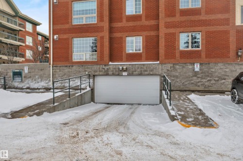 Exterior space featuring a garage and brick siding - 203 35 Sir Winston Churchill Avenue, St. Albert, AB -  With Exterior