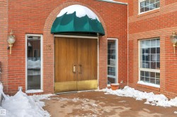 Snow covered property entrance with brick siding - 