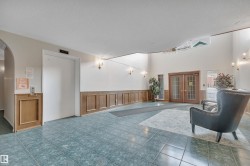 Common area with a wainscoted wall, a decorative wall, and a textured ceiling - 