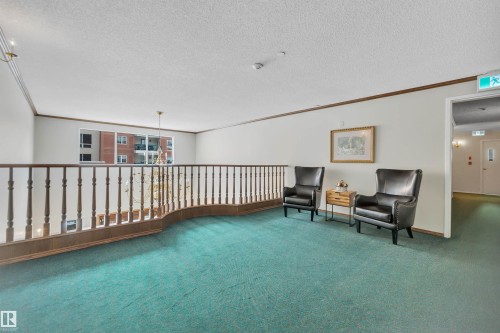 Sitting room featuring ornamental molding and a textured ceiling - 203 35 Sir Winston Churchill Avenue, St. Albert, AB - Indoor Photo Showing Other Room