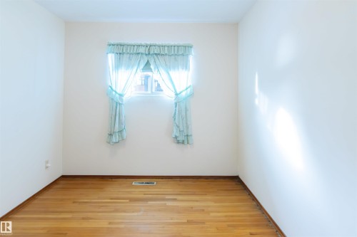 Bedroom with light wood-type flooring and baseboards - 9305 151 Street, Edmonton, AB - Indoor Photo Showing Other Room