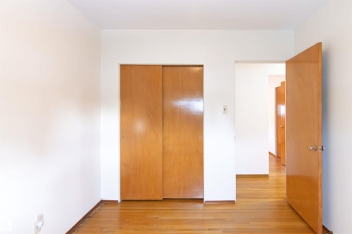 Bedroom with light wood finished floors and a closet - 9305 151 Street, Edmonton, AB - Indoor Photo Showing Other Room