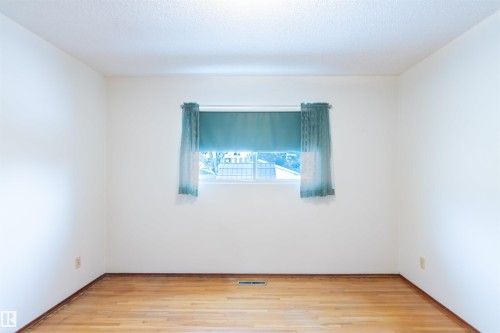 Bedroom with light wood-type flooring and baseboards - 9305 151 Street, Edmonton, AB - Indoor Photo Showing Other Room
