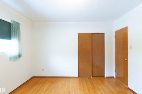 Bedroom featuring light wood-style floors, a closet, and a textured ceiling - 9305 151 Street, Edmonton, AB - Indoor Photo Showing Other Room