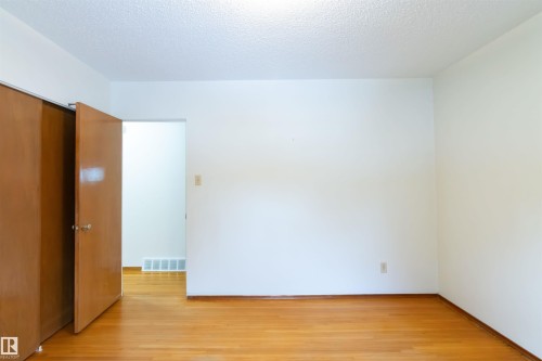 Bedroom with a textured ceiling and light wood-style flooring - 9305 151 Street, Edmonton, AB - Indoor Photo Showing Other Room