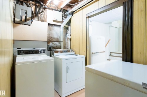 Laundry area with electric panel and washer and clothes dryer - 9305 151 Street, Edmonton, AB - Indoor Photo Showing Laundry Room