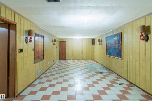 Below grade area featuring tile patterned floors and wood walls - 9305 151 Street, Edmonton, AB - Indoor Photo Showing Other Room