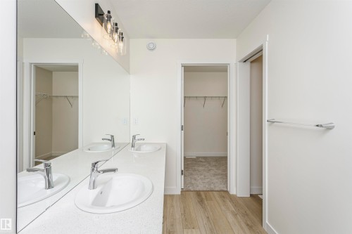 Full bath with a walk in closet, light wood finished floors, and double vanity - 5111 Kinney Way Sw, Edmonton, AB - Indoor Photo Showing Bathroom