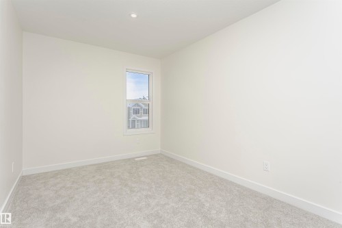 Unfurnished room with baseboards and light colored carpet - 5111 Kinney Way Sw, Edmonton, AB - Indoor Photo Showing Other Room